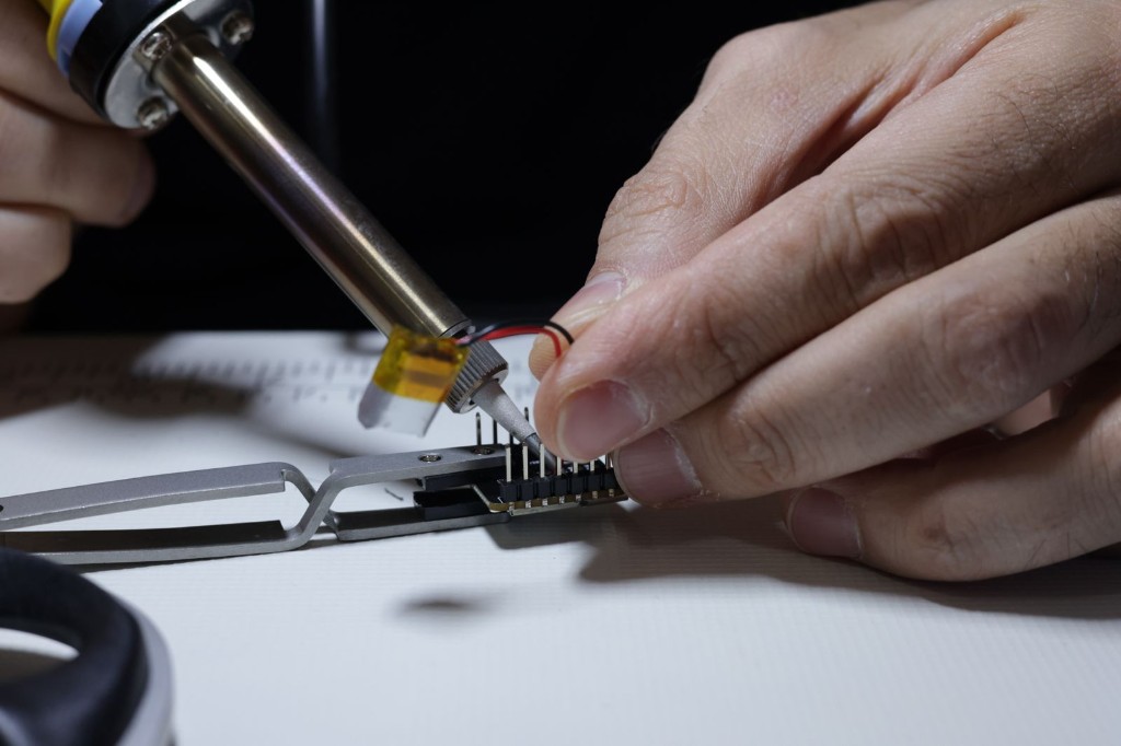 Assembling a new sensor board by hand in the lab.